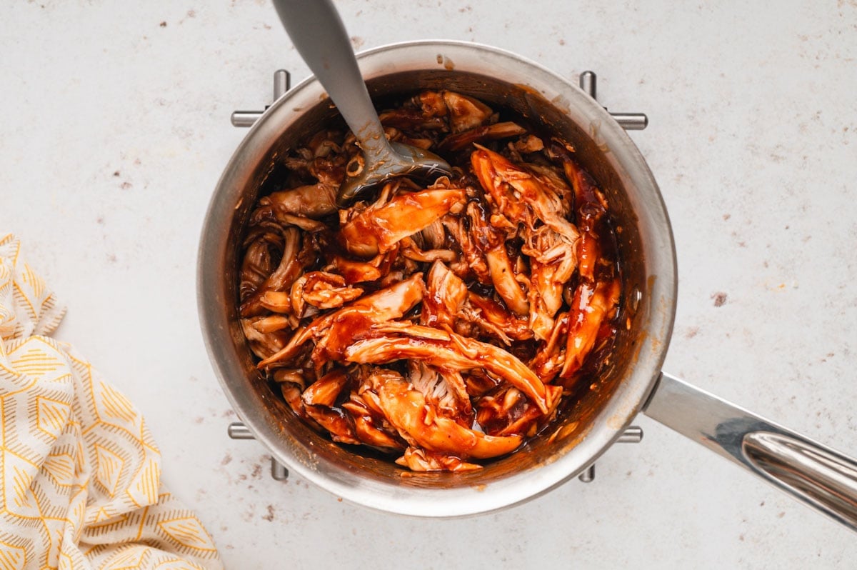 bbq sauce coated chicken in a saucepan