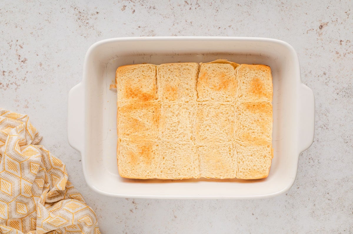 bottom half of slider buns in a white baking dish