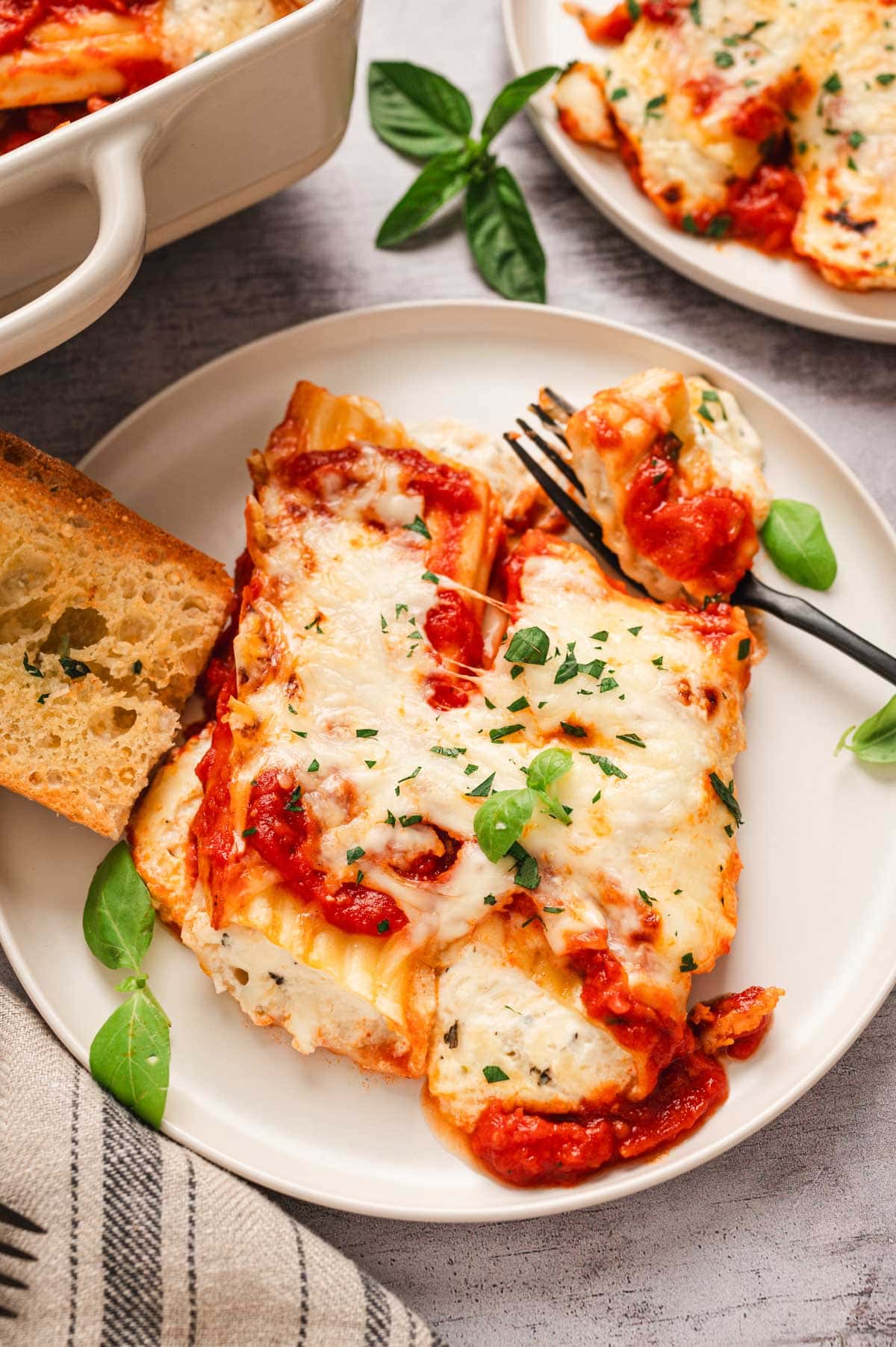 Stuffed manicotti on a plate with a fork