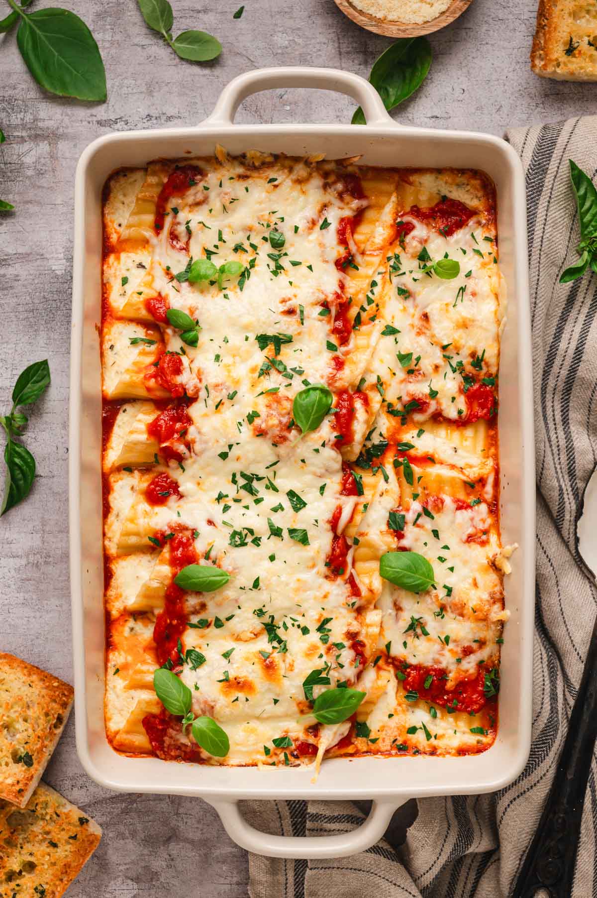 Stuffed manicotti in a baking dish.